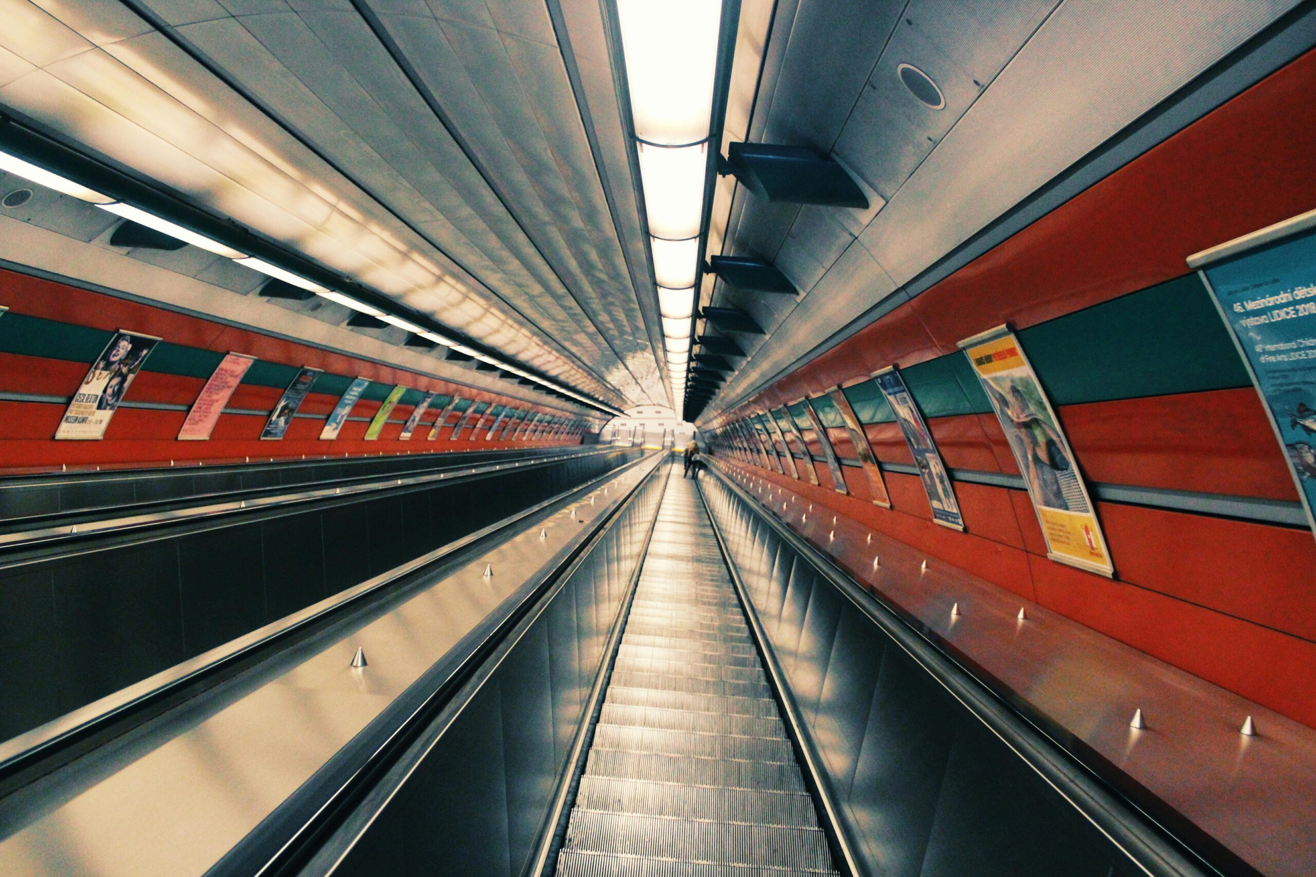 Contemporary underground escalator tunnel showcasing modern architecture and steel design.